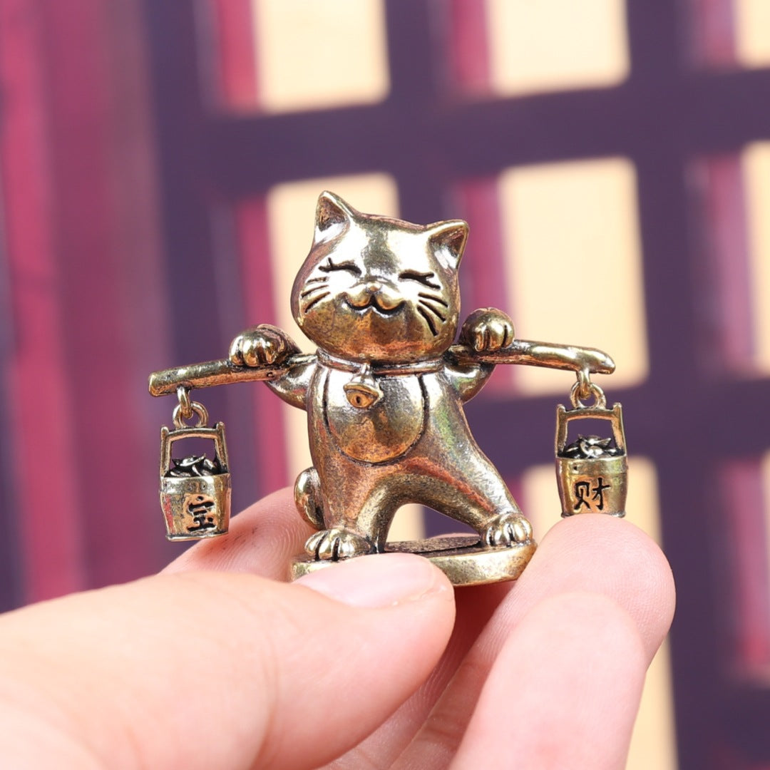 Brass money cat carrying barrels