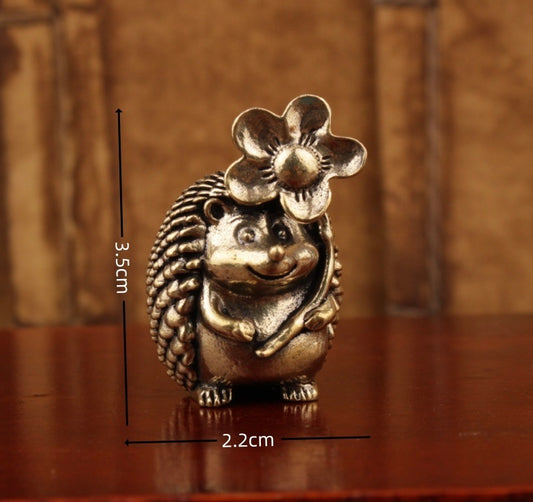 Brass hedgehog holding flower