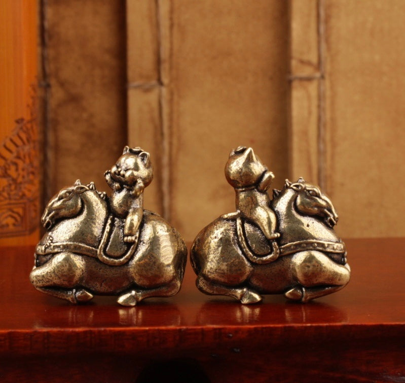 Brass kitty riding on horse