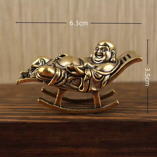 Brass happy Buddha lying on lounge