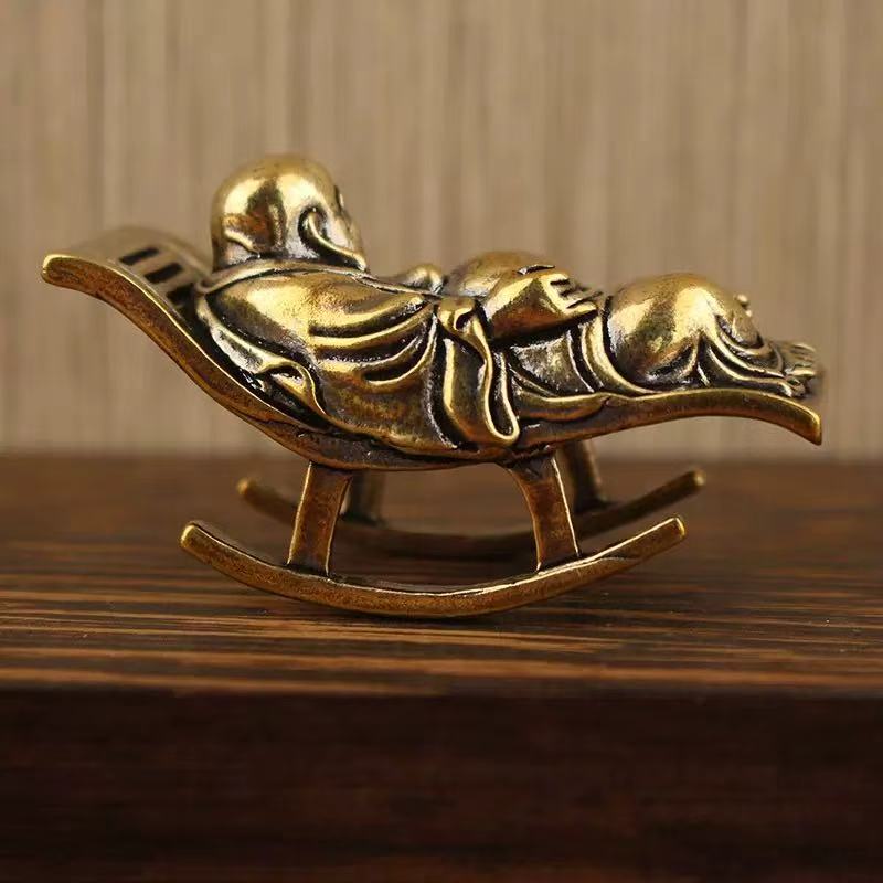 Brass happy Buddha lying on lounge