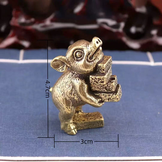 Brass pig holding books