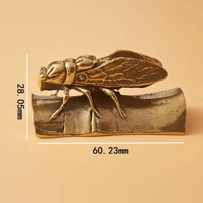 Brass cicada on bamboo